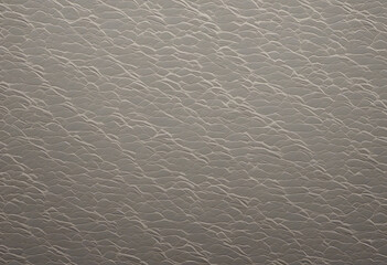 Naklejka premium A textured surface resembling waves or ripples, with a subtle sheen. The color palette is neutral, featuring soft beige and light gray tones, creating a calming effect.