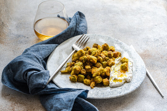 Fried bamia with sour cream sauce, dill, and garlic