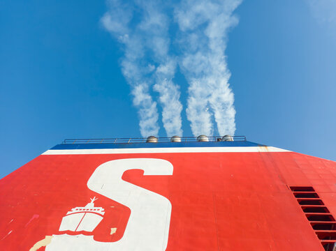 Smoke pouring out of the funnel of a passenger ferry near Felixstowe, Suffolk, UK