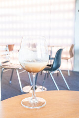 Glass of Cold Mocktail on table,female hand swirling red wine in wine glass,Friends cheering with wineglasses,eating and holidays concept..