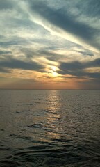 beautiful sunset on the sea with clouds and sun in the sky