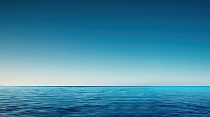 Obraz premium A smooth gradient abstract wallpaper transitioning from deep ocean blue at the bottom to a light sky blue at the top, simulating a serene horizon.