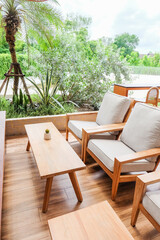 Wooden chair and wooden table in restaurant,Rattan chair in scandinavian interior of living room,Mediterranean minimal wall and green plant exterior architecturer,warm beige tones,copy space.