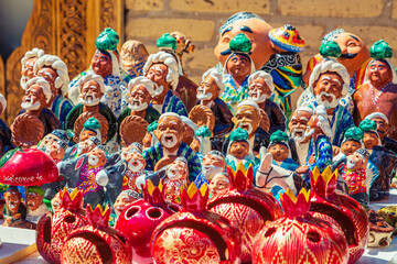 Funny ceramic figures of people at a street bazaar in Ichan Kala, Khiva's Inner Town.