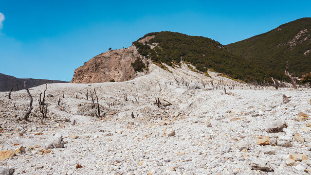 Dry landscape with rocky hill and blue sky. Landscape of death forest papandayan mountain, indonesia