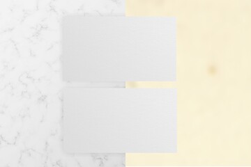 Mockup of two horizontal business cards stacks at white textured background. Angle view