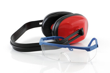 Ear defenders and safety glasses on white with reflection
