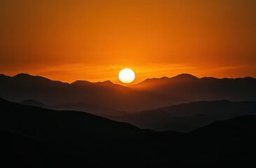 Obraz premium beautiful sunset over the hills, with a dark sky and orange sun in view