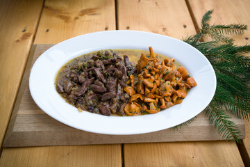 ready to eat - roasted fresh heart and kidneys from a young roebuck and chanterelles with onions and herbs, for a delicious and healthy meal