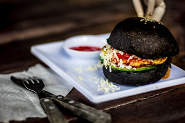 black burger on white plate