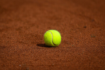 Tennis ball on clay court