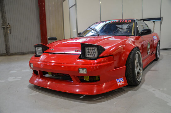 The 1990 Nissan 200SX S13 is a red sporty coupe with long, sweeping lines and pop-up headlights holds a special place in the hearts of car enthusiasts even today