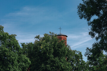 fragment of the church tower among the trees 