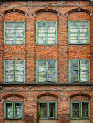 Decorated gothic brick walls and windows of luxury ancient mansion