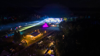 Drone photography of a music festival ar night and concert at stage during summer night