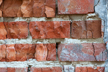 red old brick wall background, brick wall texture, structure. old broken brick, cement joints,...