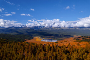 Autumn landscape Altai yellow forest crystal clear lake Dzhangyskol and snowy mountain peaks, aerial view