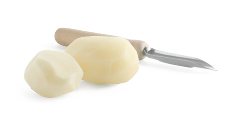 Fresh raw potatoes and peeler isolated on white