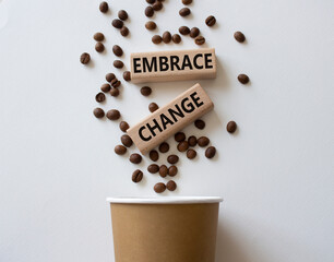Embrace change symbol. Concept word Embrace change on wooden blocks. Beautiful white background with coffee beans and cup. Business and Embrace change concept. Copy space
