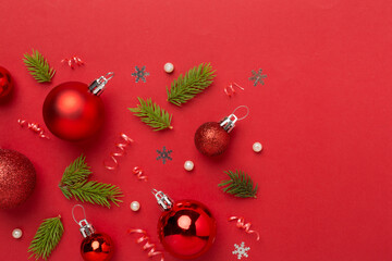 Christmas balls on color background, top view