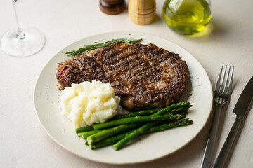 ribeye steak with asparagus and mushed potato