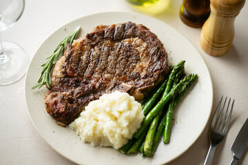 ribeye steak with asparagus and mushed potato