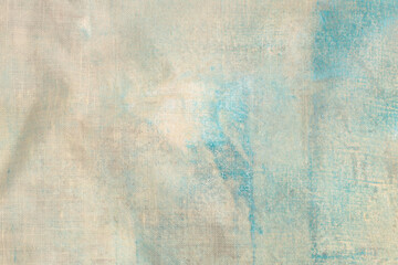 Grunge beige, brown, blue dirty canvas denim fabric stain grain texture background.