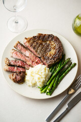 ribeye steak with asparagus and mushed potato