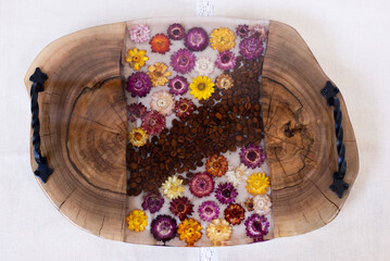 Kitchen board made of wood and epoxy resin. A tray of dried flowers and epoxy. Hand made
