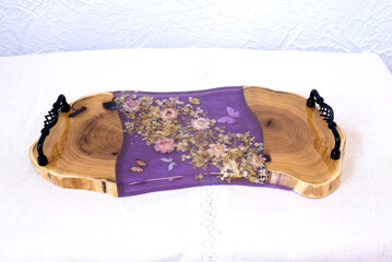 Kitchen board made of wood and epoxy resin. A tray of dried flowers and epoxy. Hand made