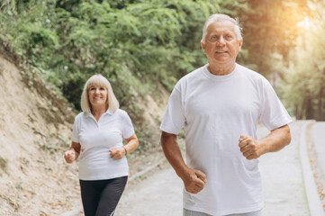 Running, sunshine and senior couple with fitness, exercise and bonding together with challenge. People in park, old man or mature woman with training, retirement and wellness with smile or lens flare