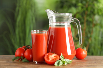 Tasty tomato juice, basil and fresh vegetables on wooden table outdoors