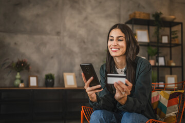 Adult woman enjoy buy online with credit card on mobile phone at home
