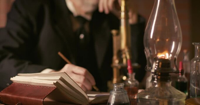 vintage scientist writing with a dip pen
