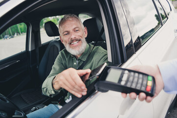 Photo of funky cool mature guy dressed casual shirt playing modern device open auto window outdoors urban car parking