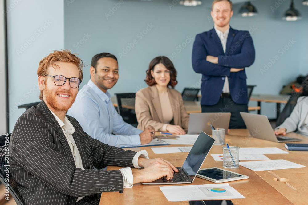 Aufkleber a group of four business professionals are working together in a modern office setting. one man is s
