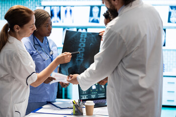 Doctors analyze human anatomy scans in a treatment center, teamwork and expertise in radiology and...