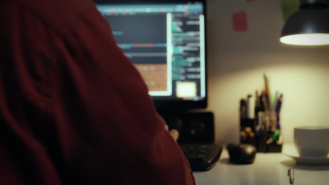 IT specialist. Young student at home purposefully works in office space in company office. Cinematic shot home worker is at work uses artificial intelligence, data