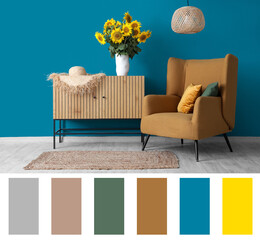Stylish room with armchair and vase of sunflowers bouquet on commode near blue wall