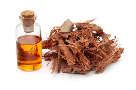 A pile of Dry Organic Arjuna Barks (Terminalia Arjuna), along with its essential oil. Isolated on a white background.