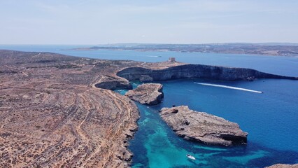 Natural windows in the rocks, Comino Island Malta, Close up revealing drone shot. High quality photo