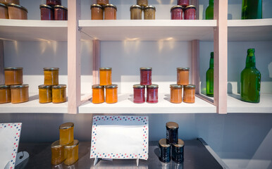 Artisanal jam and preserve jars on store shelves