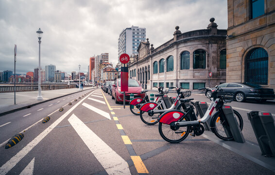 Electric bike sharing station in Gijon cityscape