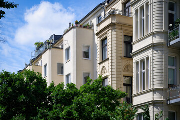 beautiful old buildings with bay windows, decorated facades and large windows next to undecorated ones with small windows