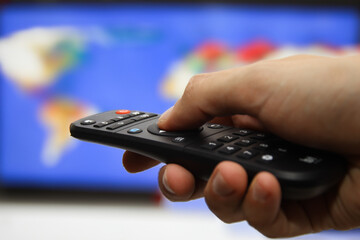 Hand Interacting with TV Remote Control