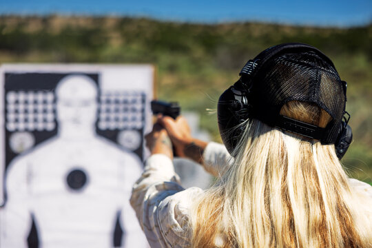 Blond woman at gun range 