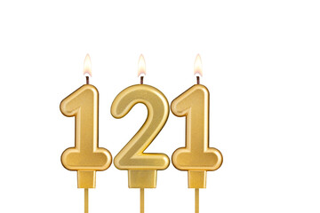 Golden number 121 birthday candle on white background