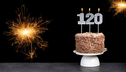 Birthday celebration with cake and candle number 120
