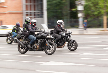 motorcyclists ride in the summer city