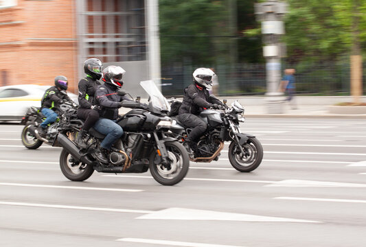 motorcyclists ride in the summer city